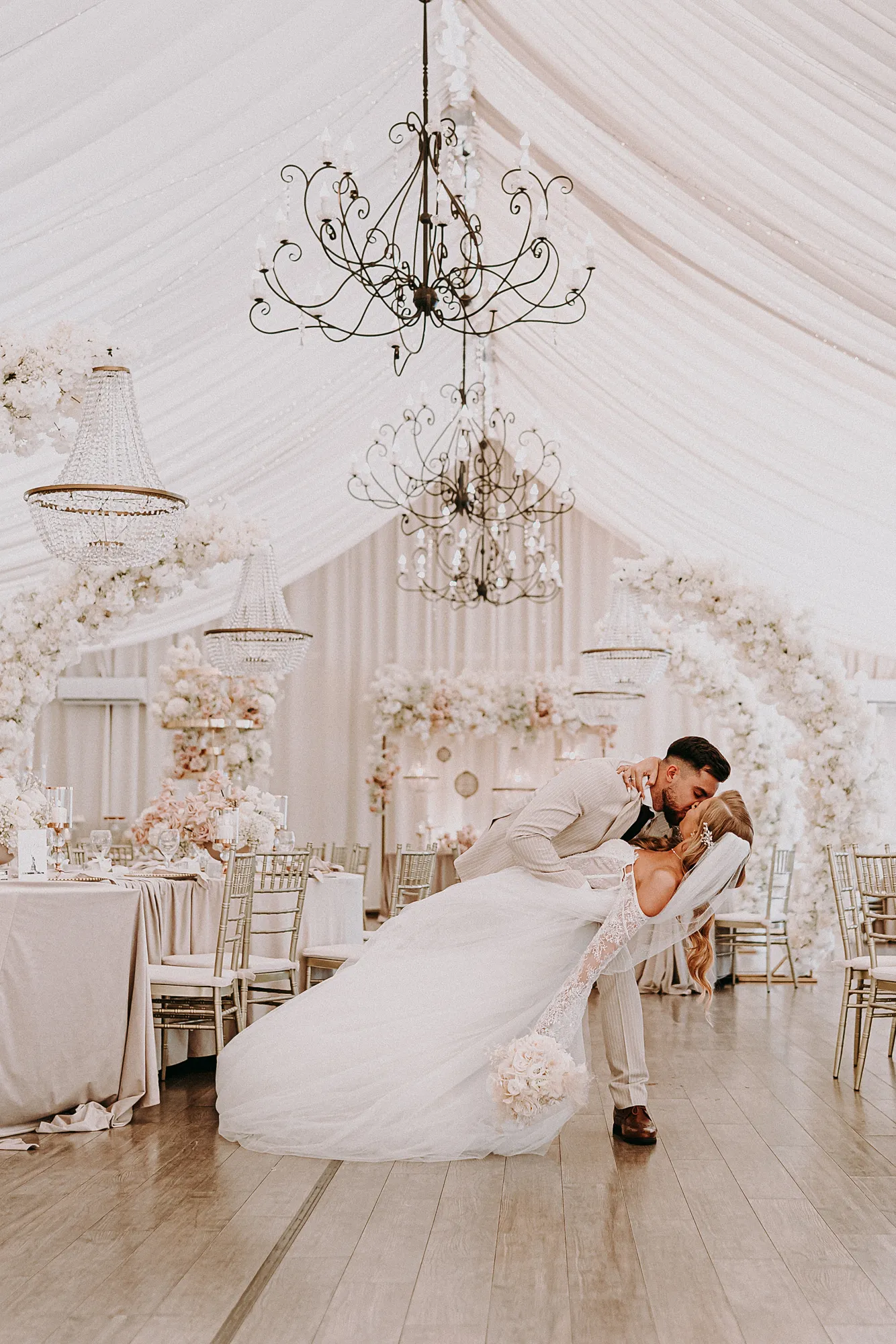 Spontaniczna reakcja nowożeńców na widok kolorowych girland i nakrytych stołów w świetlistym wnętrzu Zatoki Bajka